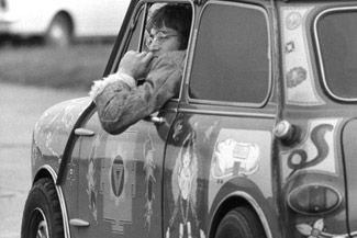 John Lennon in a psychedelic mini, owned by fellow Beatle George Harrison
